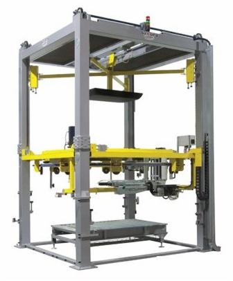 Szara, przemysłowa konstrukcja ramy z żółtymi elementami w Kielcach, prawdopodobnie część linii produkcyjnej lub maszyna pakująca, widoczna tabliczka z nazwą producenta na górze.