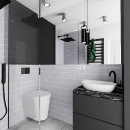 Minimalistyczna łazienka z szarymi płytkami, wiszącą toaletą, czarną armaturą i umywalką nablatową na szafce z czarnym blatem.