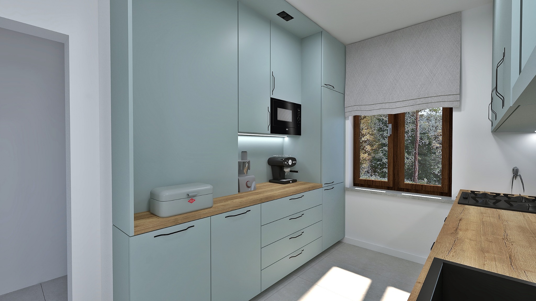 Wizualizacja kuchni z szafkami w odcieniu pastelowej zieleni, drewnianym blatem, czarnym mikrofalówką i ekspresem do kawy; widok na okno z roletą rzymską i lasem w tle.