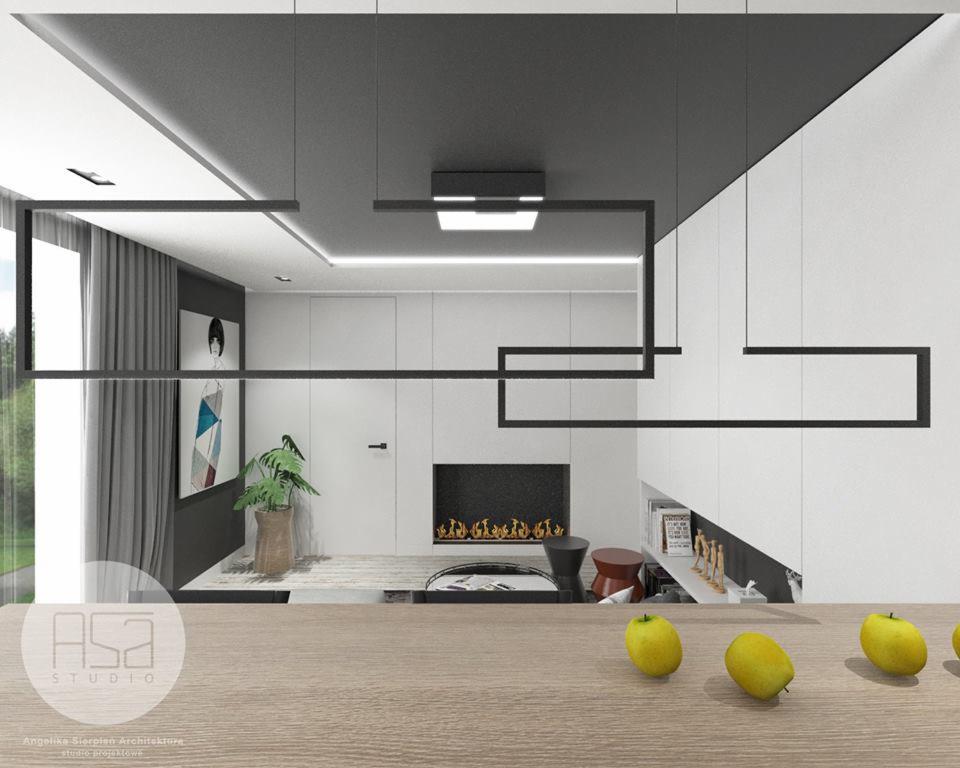 Wizualizacja nowoczesnego salonu z minimalistycznym kominkiem, geometrycznymi lampami wiszącymi i drewnianym blatem z zielonymi jabłkami na pierwszym planie.