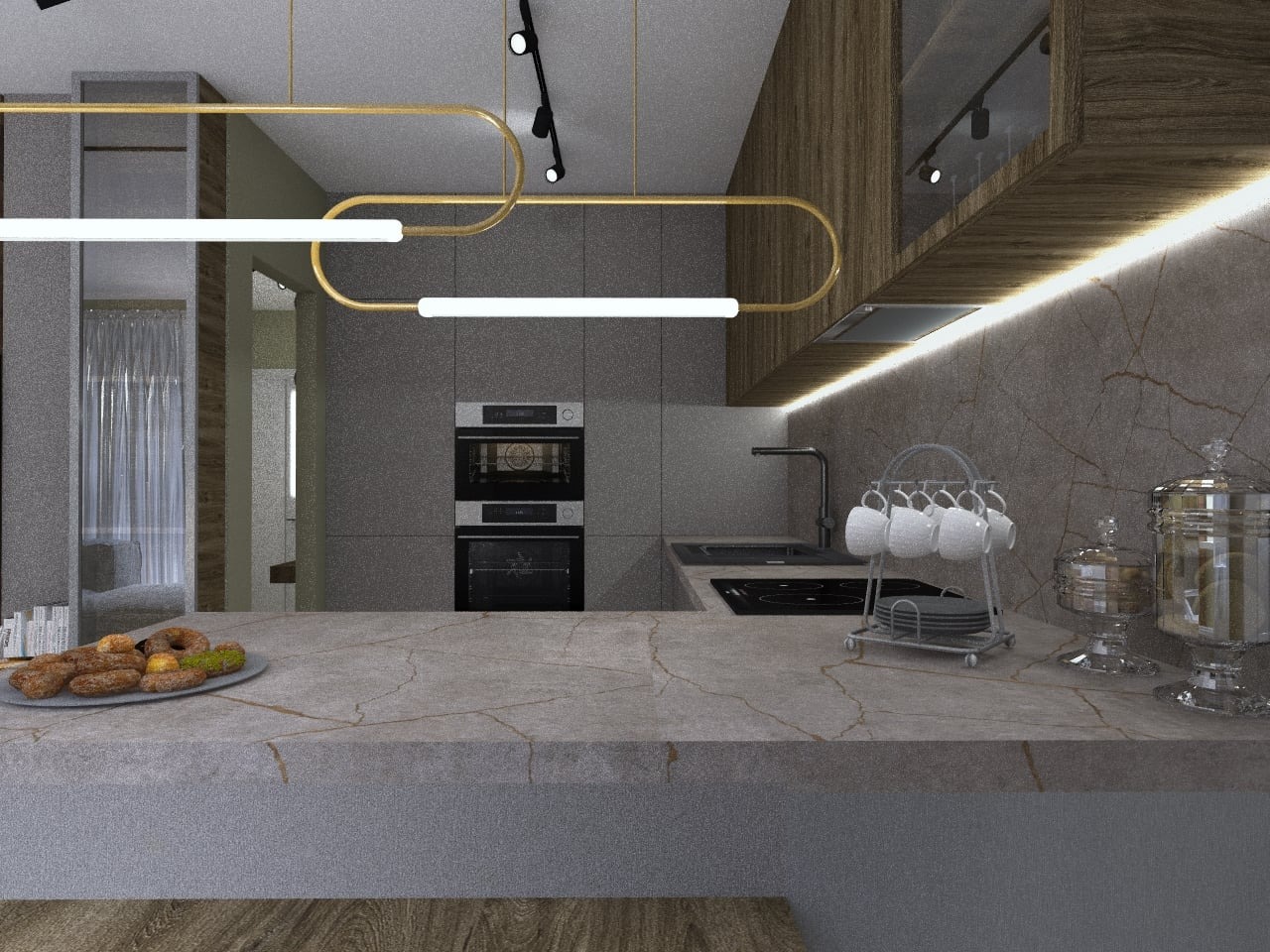 Nowoczesna kuchnia w szarościach z marmurowym blatem, złotymi lampami i ekspozycją słodkich wypieków na talerzu.