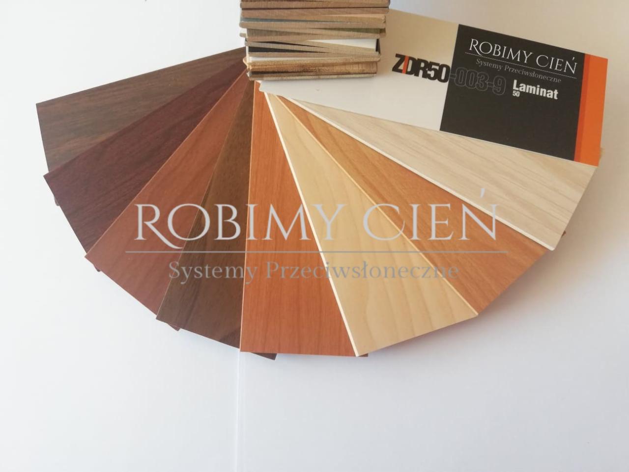 Paleta próbek kolorów i materiałów systemów przeciwsłonecznych firmy Robimy Cień, prezentująca różne odcienie drewna i laminatu, ułożona wachlarzowo na białym tle.