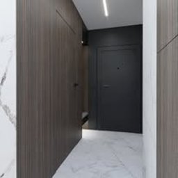 Monika Łączek IBP Custom Architecture & Design - Nowoczesny przedpokój z ciemnymi panelami drewnopodobnymi, białą marmurową podłogą i ukrytą ławką w zabudowie. Minimalistyczne oświetlenie sufitowe.