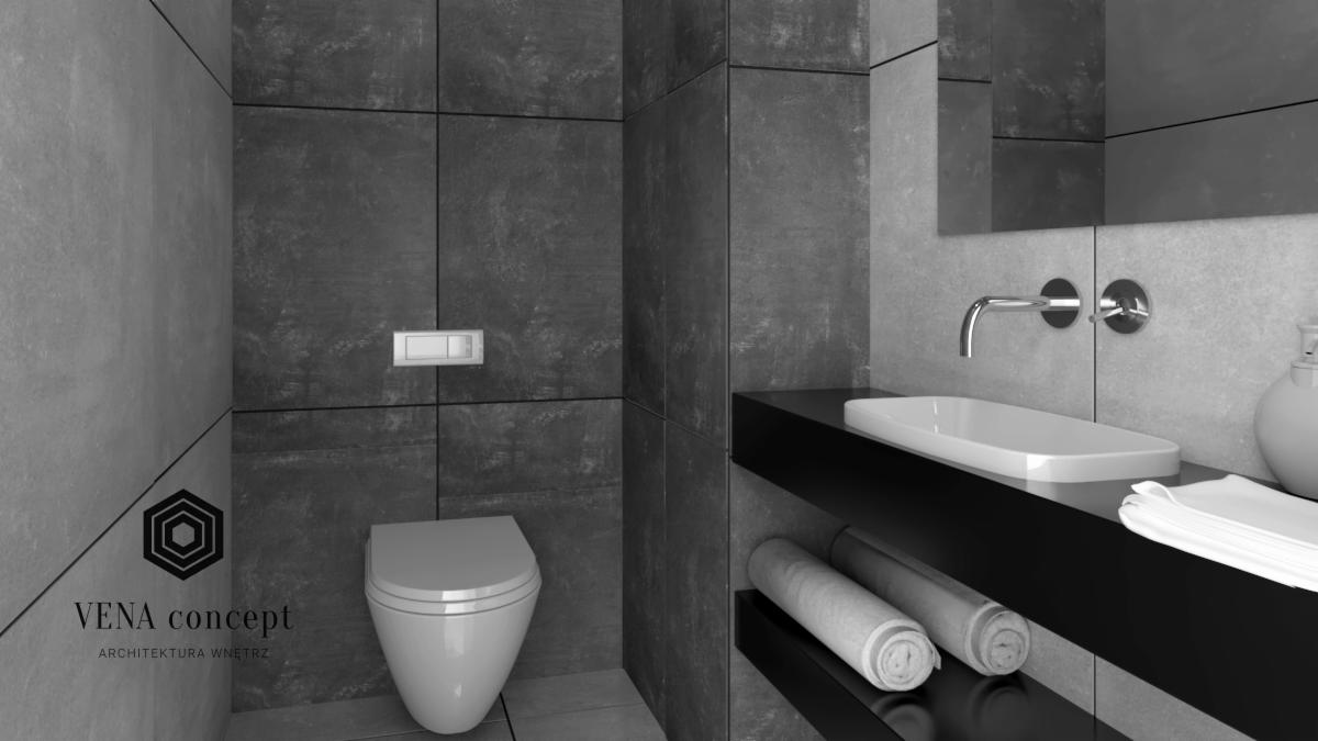 Wizualizacja nowoczesnej łazienki z szarymi płytkami, wiszącą toaletą i czarnym blatem z umywalką oraz ręcznikami, logo firmy VENA concept w lewym dolnym rogu.
