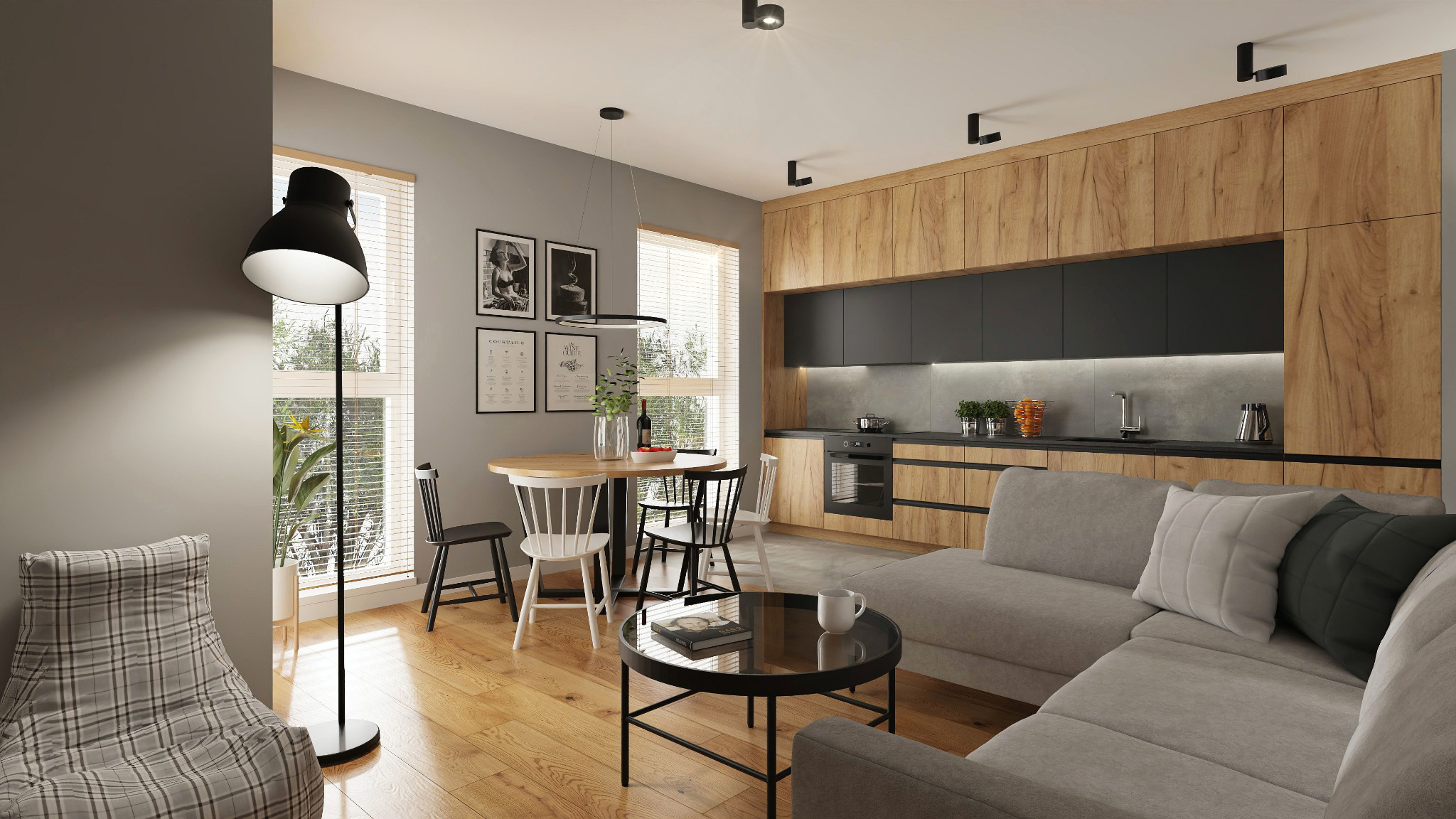 Wnętrze mieszkania w stylu skandynawskim: drewniana kuchnia z czarnymi frontami, okrągły stół z krzesłami, szara sofa narożna i lampa podłogowa.