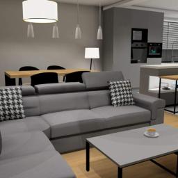 AM Projektanci - Wizualizacja przestronnego, nowoczesnego wnętrza z szarym narożnikiem, otwartą kuchnią i jadalnią, oświetlonego wiszącymi lampami.