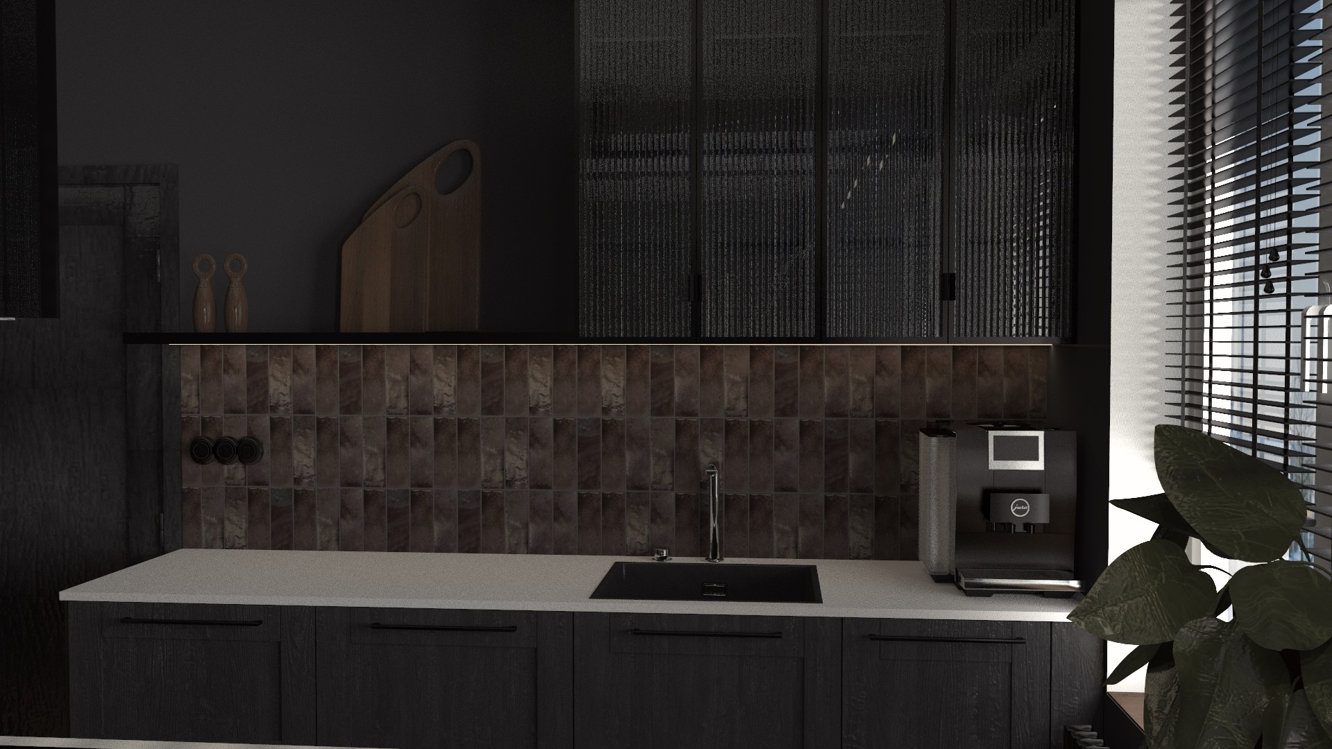 Nowoczesna, ciemna kuchnia z drewnianymi szafkami, brązowymi płytkami na ścianie, czarnym zlewem i ekspresem do kawy Jura na blacie, oświetlona światłem wpadającym przez żaluzje.