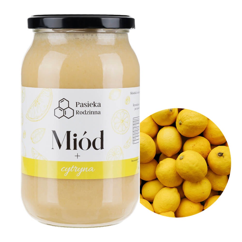 Słoik kremowanego miodu z cytryną, etykieta z nazwą 'Pasieka Rodzinna', obok okrągła kupa świeżych cytryn.