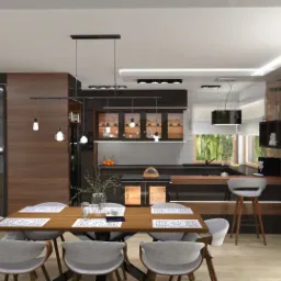 Nowoczesna kuchnia z jadalnią: drewniany stół z szarymi krzesłami, zabudowa kuchenna w odcieniach brązu i czerni, oświetlenie punktowe, ściana z drewnianych paneli, widok na zieleń za oknem.