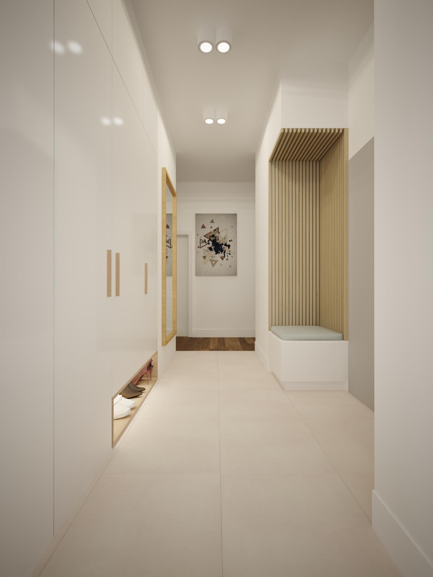 Nowoczesny przedpokój z białymi szafami w zabudowie, lustrem w złotej ramie, drewnianą ścianką z siedziskiem i abstrakcyjnym obrazem na ścianie.