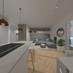 ASdesign - Wnętrze otwartego salonu z kuchnią w Bielsko-Białej. Widoczny narożnik w odcieniach szarości, drewniana podłoga w jodełkę, wyspa kuchenna z hokerami oraz wiszące lampy w stylu industrialnym.