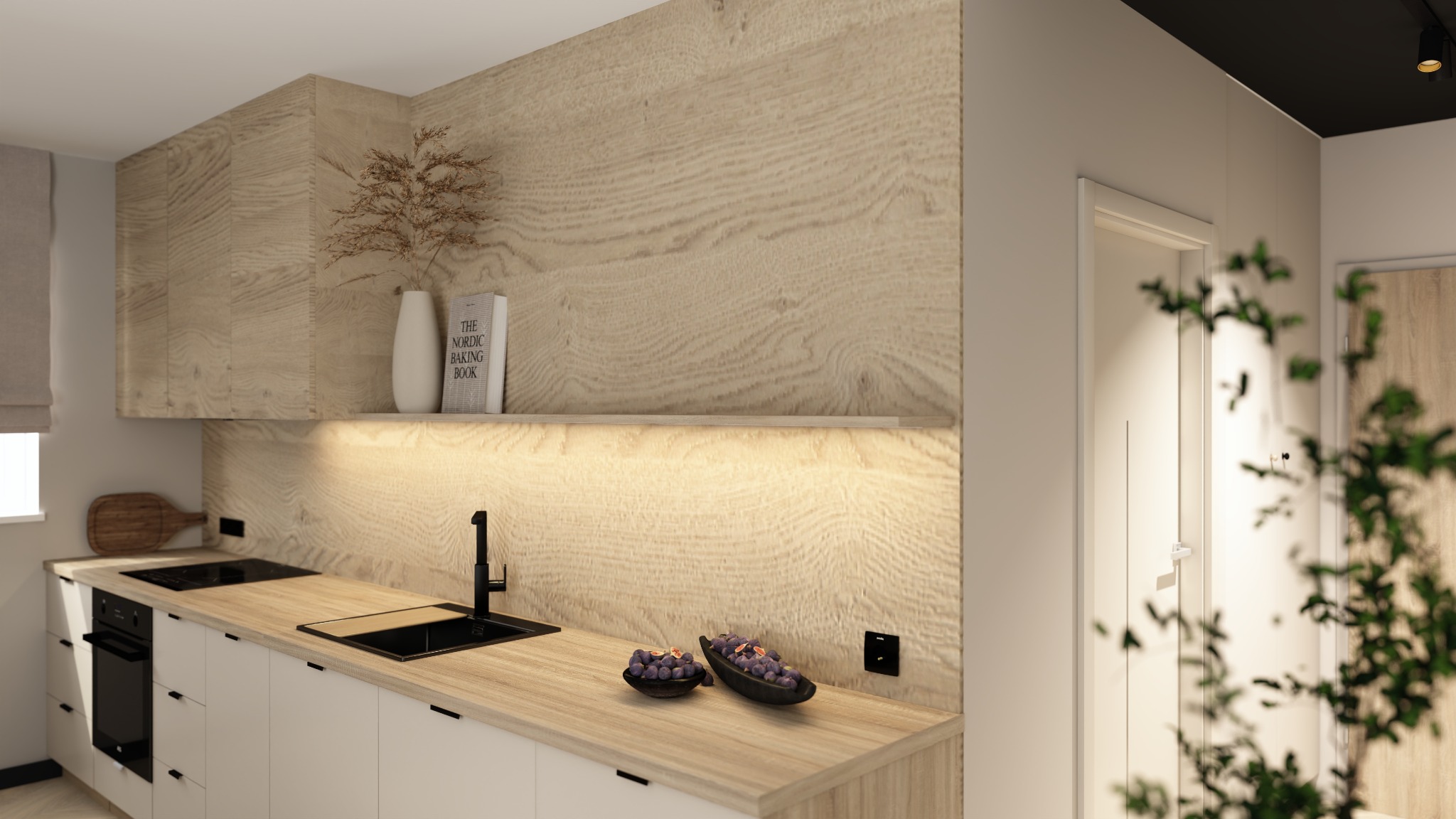 Jasna kuchnia z drewnianymi frontami i blatem, czarną armaturą i subtelnym oświetleniem LED. Na blacie dekoracyjne miseczki z owocami i książka kucharska.