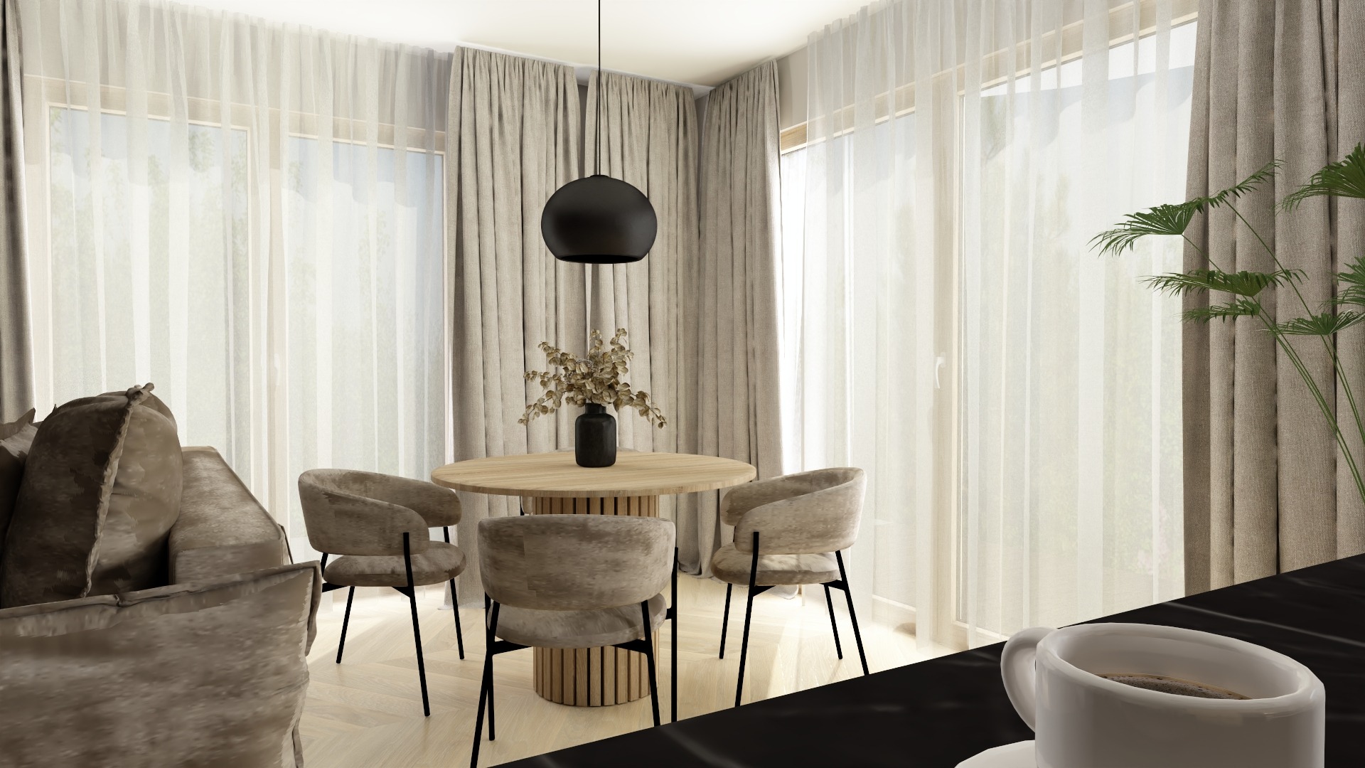 Jasne wnętrze jadalni z okrągłym stołem, krzesłami w odcieniach beżu i czarną lampą wiszącą. W tle okna z delikatnymi zasłonami i fragment sofy.