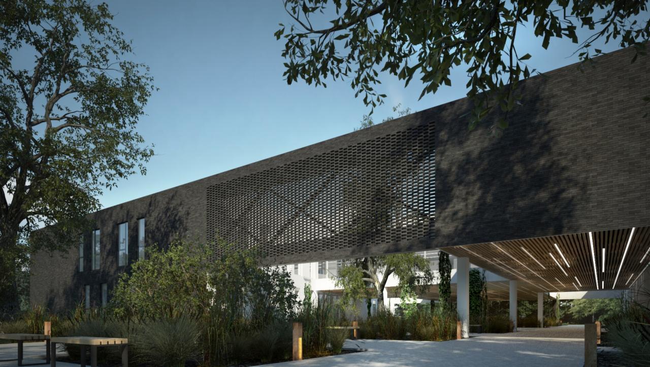 Wizualizacja nowoczesnego budynku biurowego z ciemnej cegły z charakterystycznym ażurowym panelem, otoczonego zielenią i drzewami w słoneczny dzień.