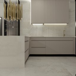 Usługi projektowania Elżbieta Kossak-Golec - Elegancka kuchnia z marmurowymi płytkami, wyspą i złotymi akcentami oświetleniowymi, ukazana w neutralnej palecie barw z perspektywy wnętrza.