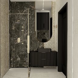 Usługi projektowania Elżbieta Kossak-Golec - Elegancka łazienka: kabina prysznicowa ze złotymi detalami, czarna umywalka na szafce z ryflowanym frontem, owalne lustro i marmurowe wykończenie ścian.