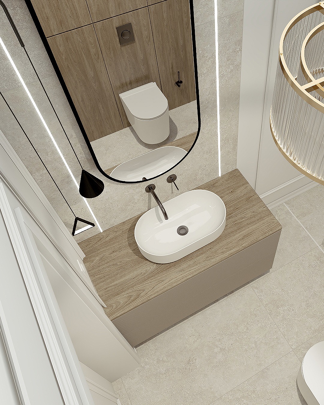 Nowoczesna łazienka z owalną umywalką nablatową na drewnianej szafce, lustro w czarnej ramie odbija toaletę, a geometryczna lampa dodaje elegancji.