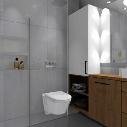 MAM PLAN Pracownia Projektowa Izabela Kiezik - Nowoczesna łazienka z szarą glazurą, podwieszaną toaletą i szafką z drewnianym blatem, oświetlenie LED w pionowej szafce, minimalistyczna armatura i wnęka z kosmetykami.