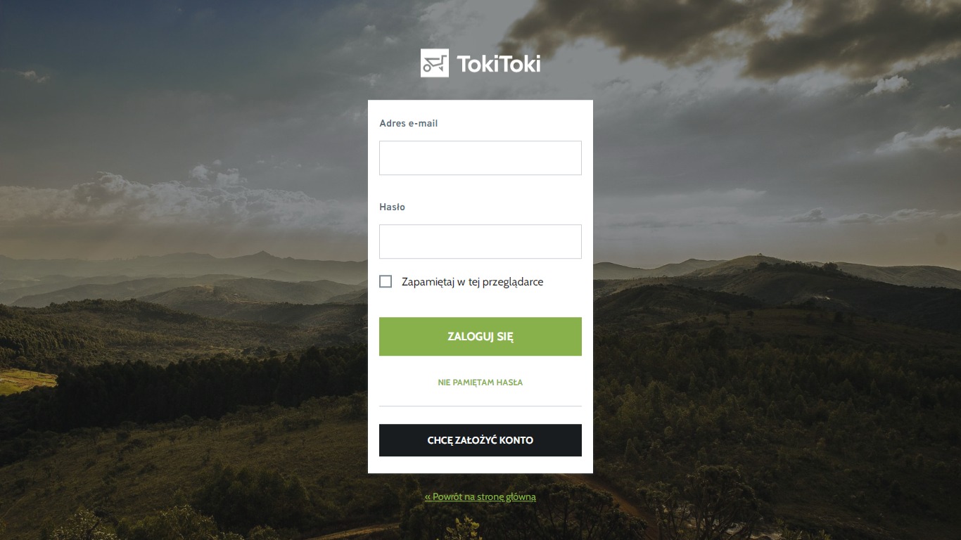 Ekran logowania do serwisu TokiToki na tle krajobrazu górskiego, z polami na adres e-mail i hasło oraz przyciskiem 'Zaloguj się'.
