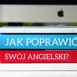 Stos książek z tytułem 'Jak poprawić swój angielski?' na tle komputera Apple.