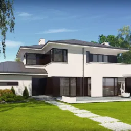 Nowoczesny, dwukondygnacyjny dom z płaskim dachem i dużymi oknami, otoczony zadbanym trawnikiem i drzewami liściastymi, widziany w słoneczny dzień.