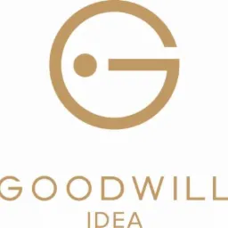 Minimalistyczne logo 'Goodwill Idea' w odcieniach beżu. Grafika łączy okrąg z elementem litery G, nad słowami 'GOODWILL' i 'IDEA'.