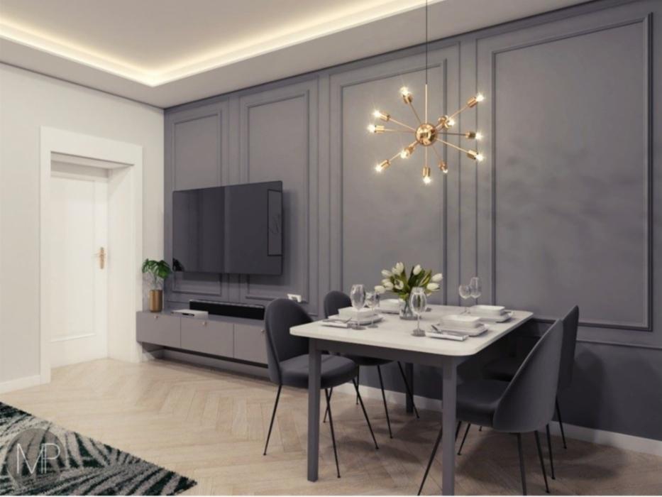 Salon z szarą ścianą z panelami, telewizorem, stolikiem jadalnym z kwiatami i nowoczesną lampą sufitową z żarówkami.