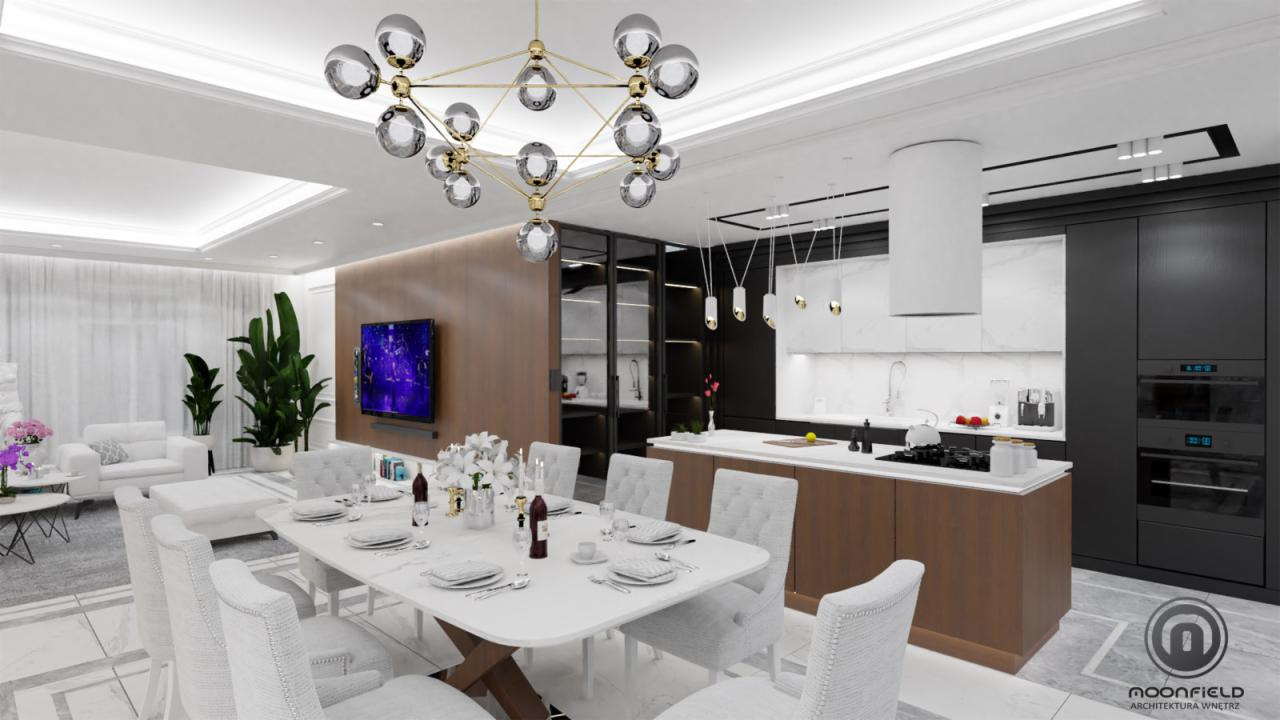 Elegancka jadalnia z elementami kuchni w stylu nowoczesnym: biały stół z kwiatami, szare krzesła, designerski żyrandol z szklanymi kulami, telewizor na drewnianej ścianie, czarno-biała zabudowa...