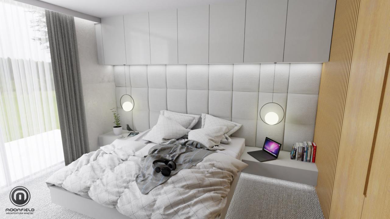 Nowoczesna sypialnia w bieli i szarościach z tapicerowanym wezgłowiem, okrągłymi lampami wiszącymi, laptopem na szafce nocnej i drewnianą ścianą z lamelami.