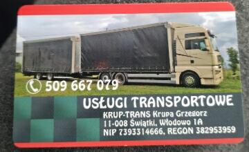 Wizytówka firmy transportowej z ilustracją beżowej ciężarówki z naczepą na czarnym tle, widoczne dane kontaktowe i adres.