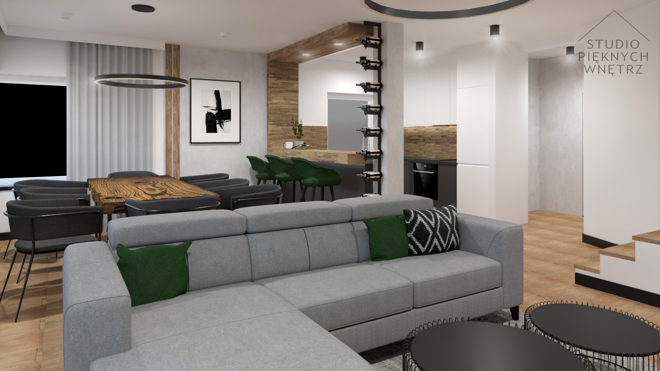 Nowoczesne wnętrze mieszkania z szarą sofą narożną, drewnianym stołem jadalnym, zielonymi krzesłami barowymi i regałem na wino.