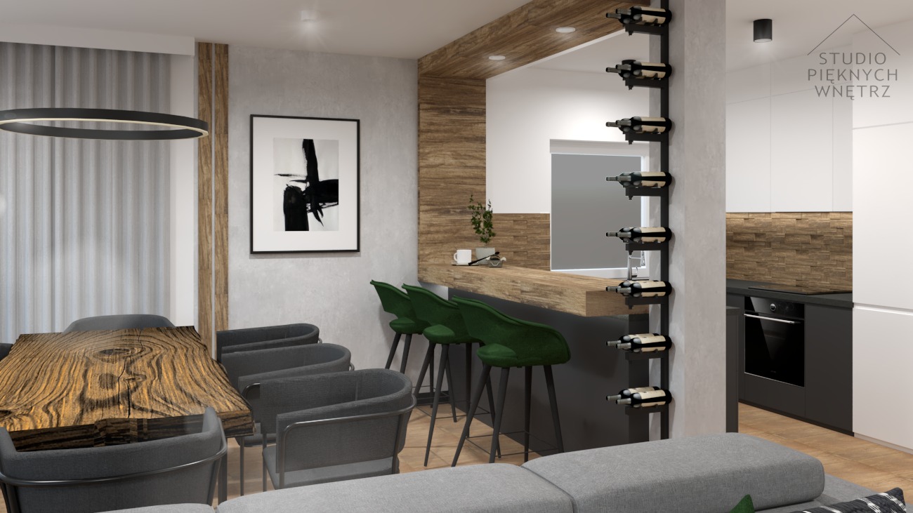 Wizualizacja wnętrza: stół z blatem z litego drewna, szare krzesła z podłokietnikami, zielone hokery przy drewnianym blacie barkowym, czarno-biały obraz na ścianie, pionowy stojak na wino, kuchnia...