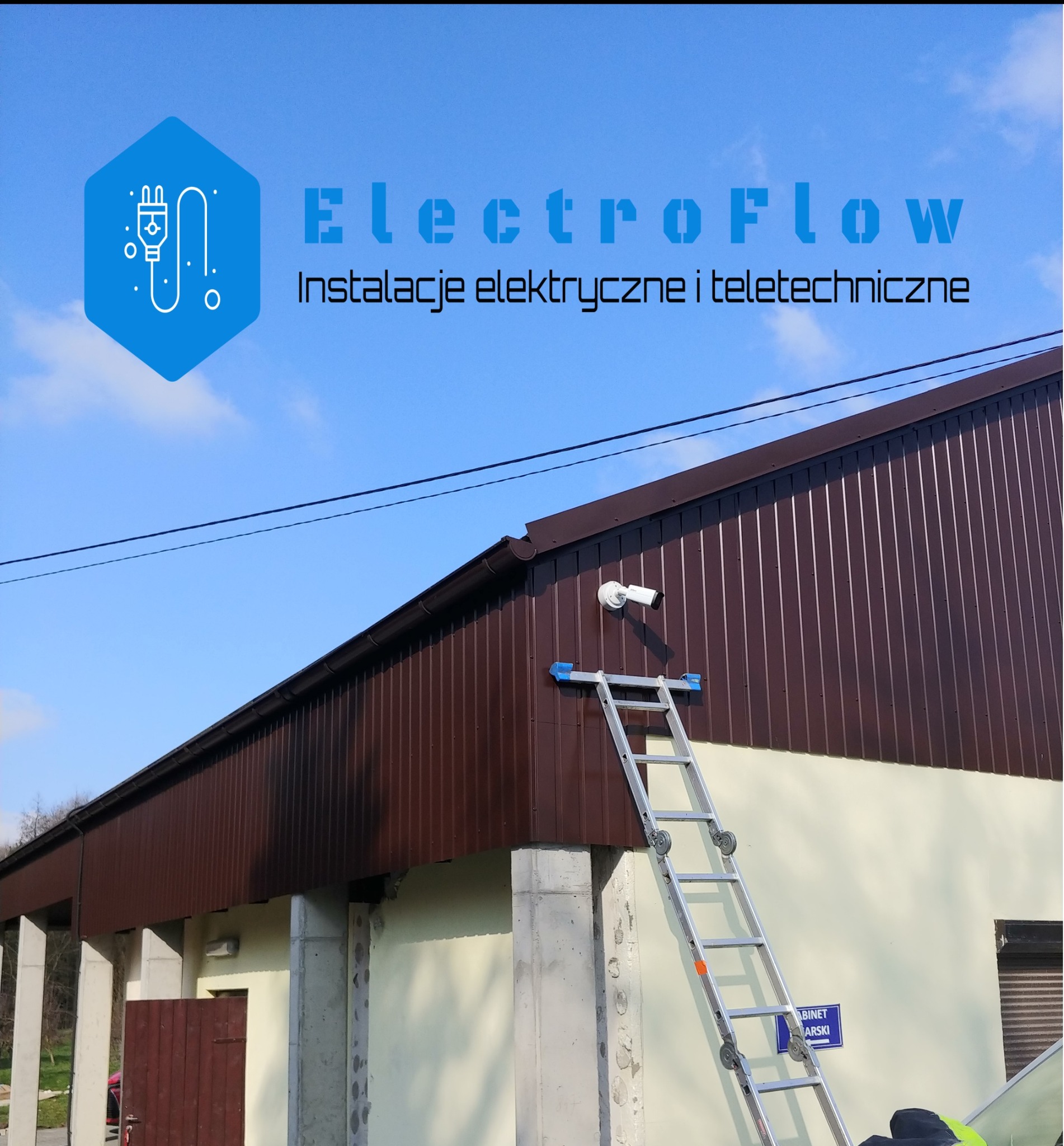 Brązowa elewacja budynku z zamontowaną białą kamerą CCTV. Obok rozstawiona drabina aluminiowa. U góry logo firmy.