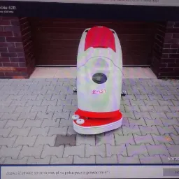 Profesjonalna maszyna czyszcząca Comac Abila 52B, stojąca na szarej kostce brukowej przed ceglanym budynkiem, widok z przodu.