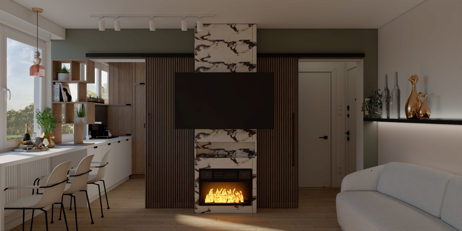 Wnętrze mieszkania z otwartą kuchnią, białymi meblami i wyspą z trzema krzesłami, ścianą TV z marmurowym wykończeniem i kominkiem elektrycznym oraz białą sofą w tle.