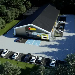 Wizualizacja 3D budynku sklepu Biedronka z parkingiem, otoczonego zielenią drzew, widok z góry.