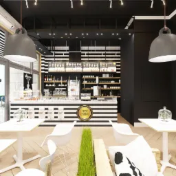 Nowoczesne wnętrze kawiarni w czarno-białej kolorystyce z akcentami zieleni, widoczne stoliki z białymi krzesłami, lada z logo 'Fresh Gelato' oraz ekspozycja produktów na półkach.