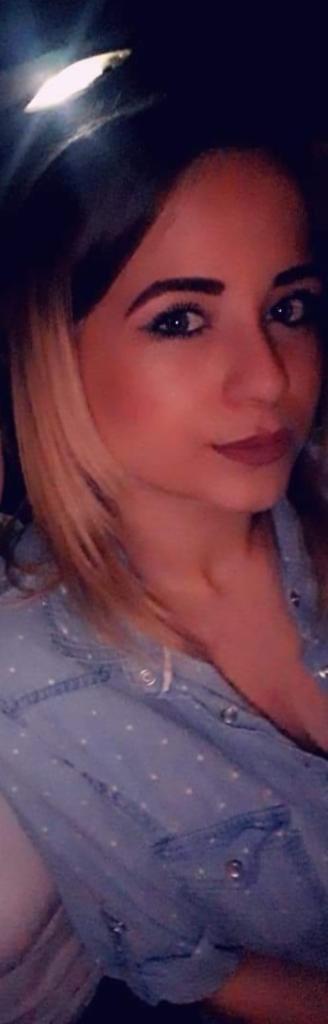 Portret kobiety z blond pasemkami, ubrana w dżinsową koszulę w białe kropki, patrząca w obiektyw.