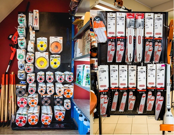 Ekspozycja w sklepie z akcesoriami ogrodniczymi: na perforowanej ścianie zawieszone opakowania z żyłkami do podkaszarek w różnych kolorach (żółty, pomarańczowy, czerwony) oraz prowadnice i łańcuchy...