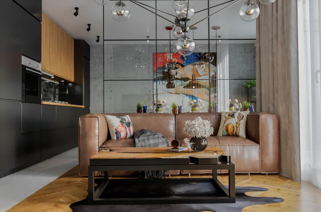 Nowoczesny salon z brązową skórzaną sofą, drewnianym stolikiem kawowym na czarnym metalowym stelażu, czarną zabudową kuchenną z drewnianymi szafkami wiszącymi, betonową ścianą z abstrakcyjnym...