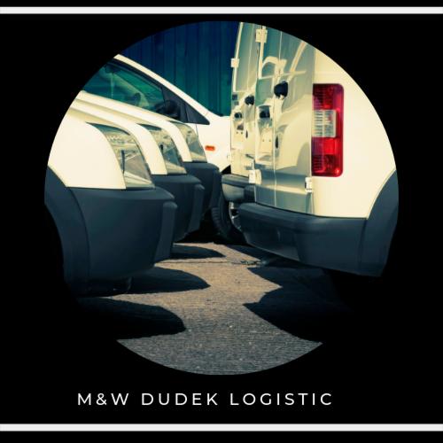 Flota białych busów zaparkowana blisko siebie, widok z niskiej perspektywy, z logo firmy M&W Dudek Logistic na dole kadru.