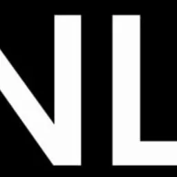 Białe litery 'STANLUKS' na czarnym tle, logo firmy.