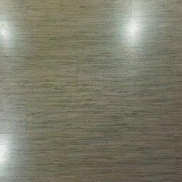 Maciej Rosiński - Nowo ułożone panele podłogowe w odcieniach beżu i szarości, z delikatną teksturą imitującą naturalne drewno, widoczne subtelne łączenia między panelami.