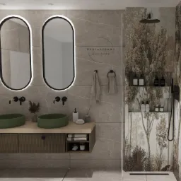 Nowoczesna łazienka z dwoma okrągłymi, zielonymi umywalkami nablatowymi, podświetlanymi owalnymi lustrami, armaturą w kolorze czarnym i kabiną prysznicową z motywem leśnym na ścianach.