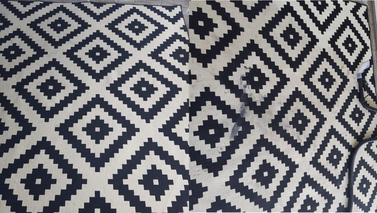 Dywan w geometryczny wzór, kontrastowe zestawienie czerni i bieli, z widocznym fragmentem wyczyszczonym, ukazującym efekt przed i po.