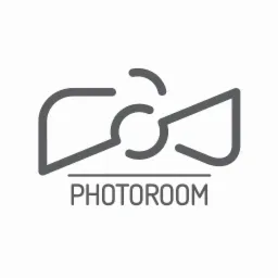 Minimalistyczny szary logotyp 'PHOTOROOM' stylizowany na obiektyw aparatu z symetrycznymi elementami po bokach, na białym tle.