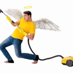 Mężczyzna przebrany za anioła z aureolą i skrzydłami, udaje, że gra na odkurzaczu jak na gitarze, ubrany w żółtą koszulkę i jeansy, z żółtymi rękawicami.