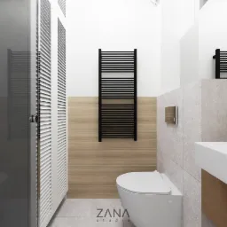Nowoczesna łazienka z wiszącą toaletą, grzejnikiem drabinkowym w kolorze czarnym, szafką z lamelami i umywalką nablatową, wykończona płytkami imitującymi drewno i kamień.