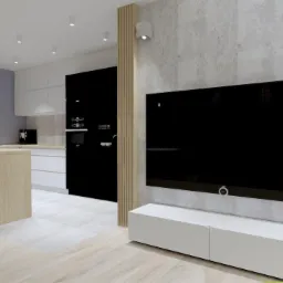 Nowoczesna kuchnia z wyspą i hokerami, połączona z salonem, minimalistyczny design, czarny sprzęt AGD, drewniane akcenty, betonowa ściana z telewizorem, białe orchidee w wazonie.