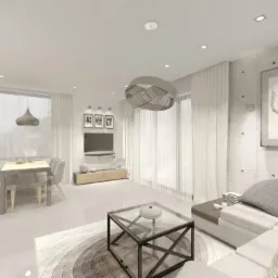 Wizualizacja jasnego salonu z jadalnią, betonowa ściana z obrazem, szara sofa modułowa z poduszkami, szklany stolik kawowy na okrągłym dywanie, białe zasłony i designerski żyrandol.